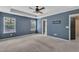 Spacious main bedroom with tray ceiling, ceiling fan, carpet floors, and bright windows at 211 Westgrove Ct, Durham, NC 27703