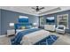 The main bedroom exhibits blue walls, a large bed with luxury bedding, and lots of natural light at 211 Westgrove Ct, Durham, NC 27703
