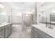 Bright bathroom featuring double sink vanity, soaking tub, and walk-in shower with glass door at 2128 Jollay St, Durham, NC 27703