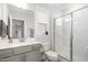 Elegant bathroom featuring a glass shower, neutral walls and a window at 2128 Jollay St, Durham, NC 27703