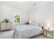 Bright bedroom features a paisley patterned duvet, neutral walls, and large window at 2128 Jollay St, Durham, NC 27703