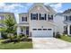 Charming two-story home with a well-manicured lawn, lush landscaping, and attached garage at 2128 Jollay St, Durham, NC 27703
