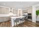 Modern kitchen with stainless steel appliances, island seating, and a subway tile backsplash at 2128 Jollay St, Durham, NC 27703