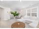 Bright and airy living room featuring a comfortable white sectional sofa and a wooden coffee table at 2128 Jollay St, Durham, NC 27703