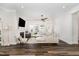 Bright, open living space with a fireplace, ceiling fan and hardwood floors at 2128 Jollay St, Durham, NC 27703