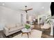 Open concept living room and kitchen with hardwood floors and a ceiling fan at 2128 Jollay St, Durham, NC 27703