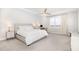 Bright, carpeted main bedroom featuring a ceiling fan and large window at 2128 Jollay St, Durham, NC 27703