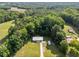 A lovely property featuring a home, shed, long drive, a yard and beautiful forest views at 2210 Pilot-Riley Rd, Zebulon, NC 27597
