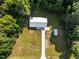 Overhead view of house, shed, and expansive driveway surrounded by lush trees at 2210 Pilot-Riley Rd, Zebulon, NC 27597