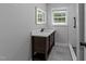 Bathroom with a modern vanity, illuminated mirror, and sleek tile flooring at 2210 Pilot-Riley Rd, Zebulon, NC 27597