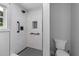 Modern bathroom featuring a walk-in shower with black hardware and sleek tile at 2210 Pilot-Riley Rd, Zebulon, NC 27597