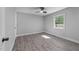 Neutral bedroom with hardwood floors, ceiling fan, and a bright window at 2210 Pilot-Riley Rd, Zebulon, NC 27597