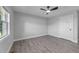 Bedroom featuring hardwood floors, ceiling fan, and bright window at 2210 Pilot-Riley Rd, Zebulon, NC 27597