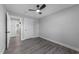 Bedroom featuring hardwood floors, ceiling fan, and two entry doors at 2210 Pilot-Riley Rd, Zebulon, NC 27597