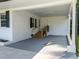 An expansive carport featuring newly finished concrete and wooden steps, offering a blend of utility and curb appeal at 2210 Pilot-Riley Rd, Zebulon, NC 27597