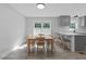 Bright dining area featuring a wood table, seating for six, and a modern kitchen bar at 2210 Pilot-Riley Rd, Zebulon, NC 27597