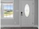 Up close view of entryway with new floors, door with oval window, and window at 2210 Pilot-Riley Rd, Zebulon, NC 27597
