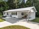 Side view of this charming white-brick home showing a carport and nice lawn at 2210 Pilot-Riley Rd, Zebulon, NC 27597