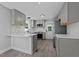 Renovated kitchen featuring gray cabinets, stainless steel appliances, white countertops, and stylish backsplash at 2210 Pilot-Riley Rd, Zebulon, NC 27597
