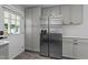 Stainless steel refrigerator and gray cabinets in a renovated kitchen with a stylish backsplash at 2210 Pilot-Riley Rd, Zebulon, NC 27597