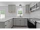 The renovated kitchen featuring stainless steel appliances, white countertops, and stylish backsplash at 2210 Pilot-Riley Rd, Zebulon, NC 27597