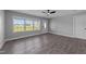 Spacious living room with new floors, a ceiling fan, and large window for natural light at 2210 Pilot-Riley Rd, Zebulon, NC 27597