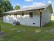 White home showcasing exterior details, including the windows, air conditioning unit, and manicured lawn at 2210 Pilot-Riley Rd, Zebulon, NC 27597