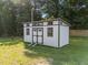 The large storage shed offers ample space and features a white exterior with black trim at 2210 Pilot-Riley Rd, Zebulon, NC 27597