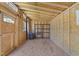 The shed is equipped with a window, wood framing, and shelving, offering ample space for organized storage solutions at 2210 Pilot-Riley Rd, Zebulon, NC 27597