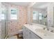 Bathroom features a double vanity with matching mirror and floral wallpaper, with natural light from a window at 2225 Creston Rd, Raleigh, NC 27608
