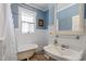 Charming bathroom with a clawfoot tub, marble floors, and painted blue walls at 2225 Creston Rd, Raleigh, NC 27608