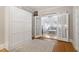 Bedroom with Murphy bed, hardwood floors, and French doors leading into the living area at 2225 Creston Rd, Raleigh, NC 27608