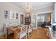 Dining room includes a wooden table with table settings, decorated in blue and white, with chairs and a chandelier at 2225 Creston Rd, Raleigh, NC 27608