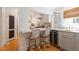 Modern kitchen featuring a breakfast bar with seating, a built-in wine fridge, and marble countertops at 2225 Creston Rd, Raleigh, NC 27608