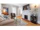 Cozy living room with a fireplace, a glass table and hardwood floors at 2225 Creston Rd, Raleigh, NC 27608