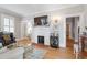 Bright living room featuring a fireplace, hardwood floors, and french doors at 2225 Creston Rd, Raleigh, NC 27608