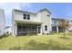 The home's backyard features a manicured lawn, and a screened in porch at 2264 Jollay St, Durham, NC 27703