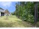 The home's spacious backyard features a manicured lawn, and mature trees at 2264 Jollay St, Durham, NC 27703