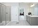 Modern bathroom with a glass shower enclosure, a vanity with a white countertop, and gray cabinets at 2264 Jollay St, Durham, NC 27703