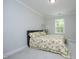 Comfortable bedroom featuring a floral bedspread and a window for natural light at 2264 Jollay St, Durham, NC 27703
