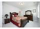 Spacious bedroom features a bed, dresser with mirror, and carpet floors at 2264 Jollay St, Durham, NC 27703
