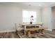Bright dining room with a farmhouse-style table, bench seating, and stylish decor at 2264 Jollay St, Durham, NC 27703