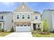 Charming two-story home featuring stone accents, a two-car garage, and a well-maintained front yard at 2264 Jollay St, Durham, NC 27703