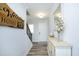 Inviting foyer featuring wood-look floors, staircase, and an elegant console table with decor at 2264 Jollay St, Durham, NC 27703