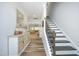 Bright foyer with wood-look floors, a staircase, and a view into the adjacent living areas at 2264 Jollay St, Durham, NC 27703