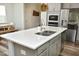 Spacious kitchen island with a sink and quartz countertops, perfect for meal prep and entertaining at 2264 Jollay St, Durham, NC 27703