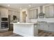 Modern kitchen with stainless steel appliances, gray cabinets, and a stylish center island at 2264 Jollay St, Durham, NC 27703