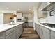 Well-lit kitchen featuring gray cabinets, stainless steel appliances, and sleek countertops at 2264 Jollay St, Durham, NC 27703