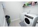 Functional laundry room with modern washer and dryer units and convenient shelving at 2264 Jollay St, Durham, NC 27703