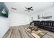 Open living room with dual black leather sofas, ceiling fan and nice vinyl flooring at 2264 Jollay St, Durham, NC 27703